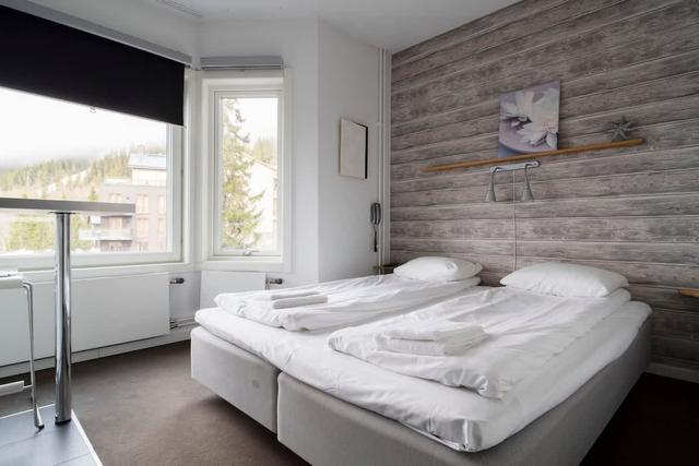 Studio living area, compact kitchen with microwave, bathroom with shower, storage hallway, panoramic lake view