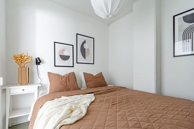 Living room with sofa bed and office space in Södermalm apartment