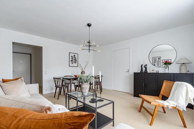 Living room with sofa bed and dining table in Södermalm apartment