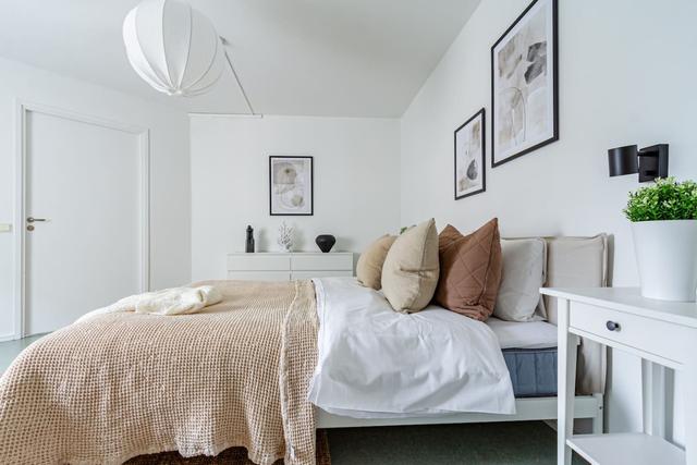 Living room with sofa bed and office space in Södermalm apartment