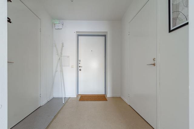 Living room with sofa bed and dining table in Södermalm apartment