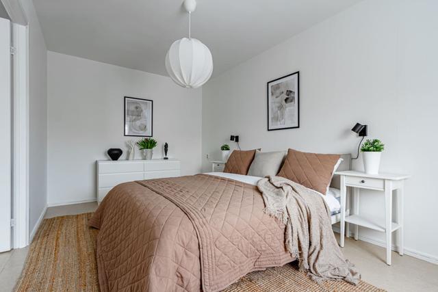 Living room with sofa bed and dining table in Södermalm apartment