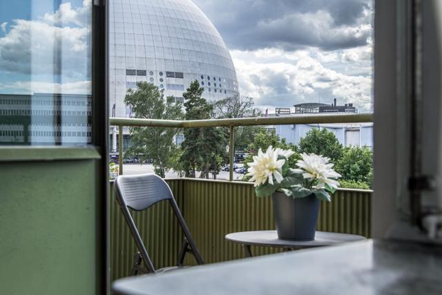 Comfortable living room with balcony access in Globen apartment