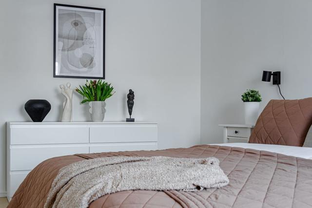 Living room with dining table and sofa bed in Södermalm apartment.