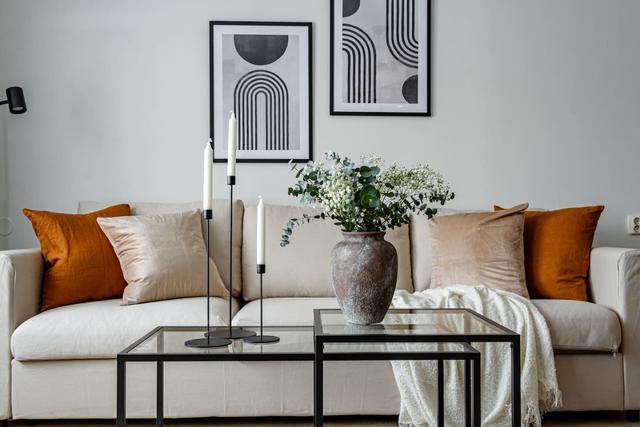 Living room with sofa bed and dining table in Södermalm apartment