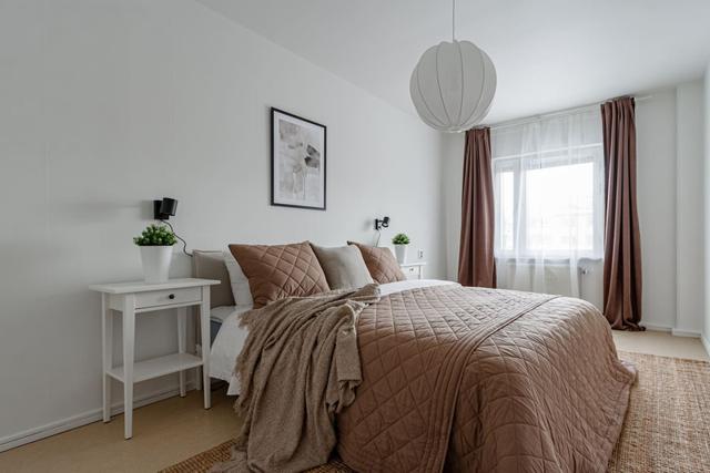 Living room with sofa bed and dining table in Södermalm apartment