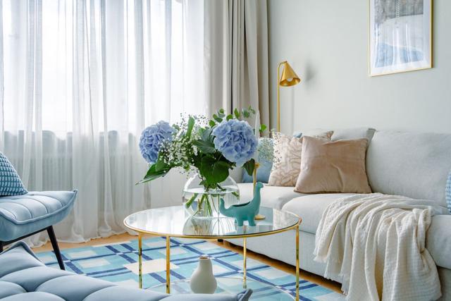 Living room with sofa bed and armchair in Kungsholmen apartment.