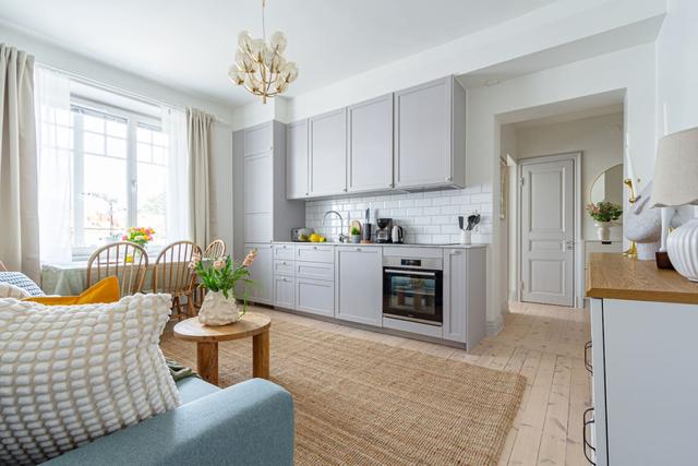 Open-concept living room and kitchen in a stylish apartment.