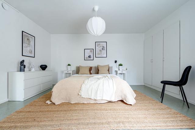 Living room with sofa bed and office space in Södermalm apartment