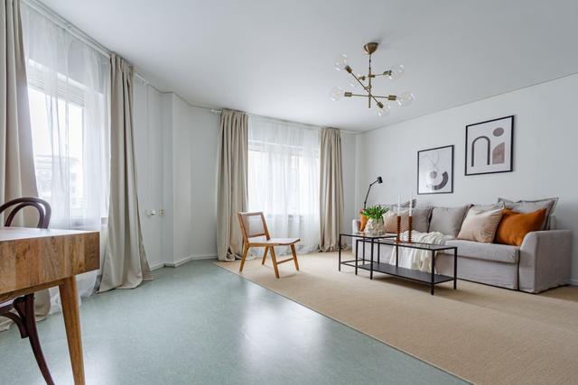 Living room with sofa bed and office space in Södermalm apartment