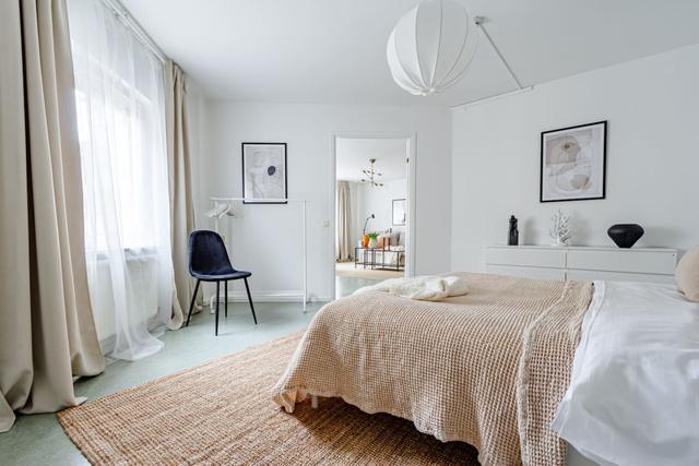 Living room with sofa bed and office space in Södermalm apartment