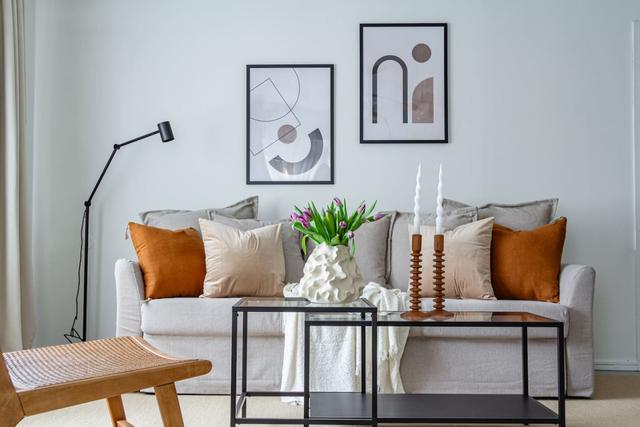 Living room with sofa bed and office space in Södermalm apartment