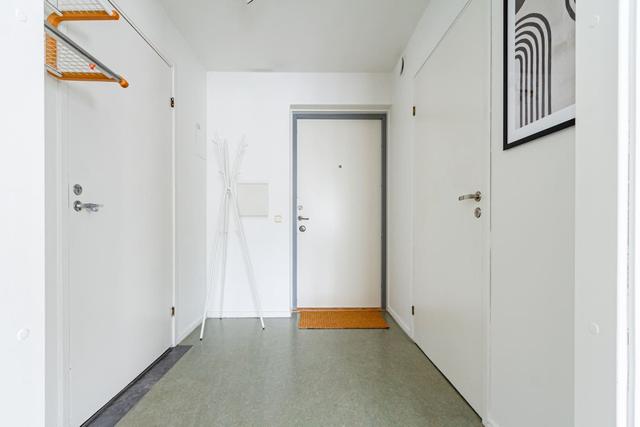 Living room with sofa bed and office space in Södermalm apartment