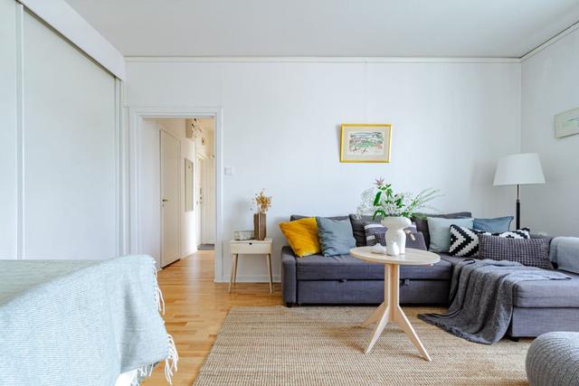 Comfortable living room with balcony access in Globen apartment