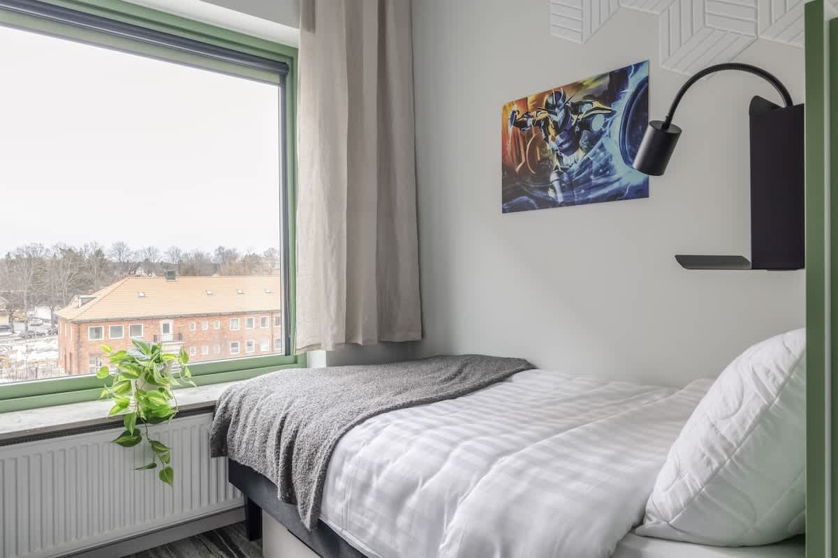 Terrace with seating at HomeX Hotel Täby"<br>"Shared lounge with modern décor at HomeX Hotel Täby"<br>"Game lounge area in HomeX Hotel Täby"<br>"Communal kitchen and dining at HomeX Hotel Täby"<br>"Cozy lounge seating at HomeX Hotel Täby