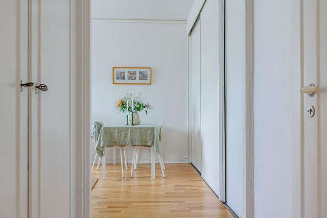 Comfortable living room with balcony access in Globen apartment