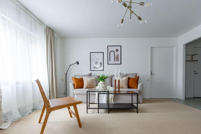 Living room with sofa bed and office space in Södermalm apartment