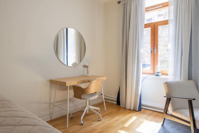 Cozy dining area for two by the large window in Gothenburg.