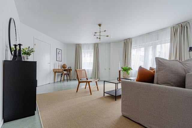 Living room with sofa bed and office space in Södermalm apartment