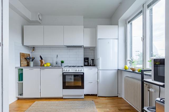 Comfortable living room with balcony access in Globen apartment