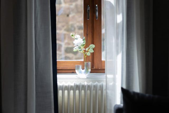 Cozy dining area for two by the large window in Gothenburg.