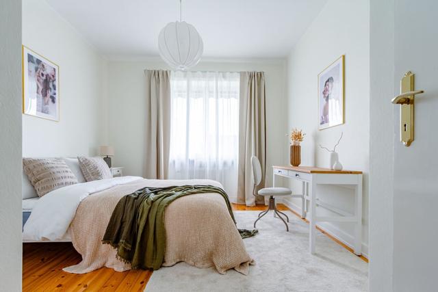 Living room with sofa bed and armchair in Kungsholmen apartment.