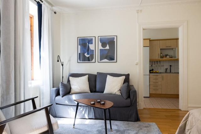 Cozy dining area for two by the large window in Gothenburg.