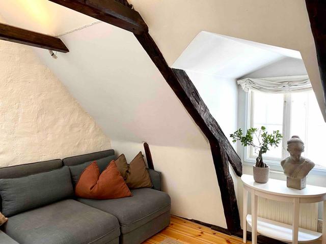 Loft apartment in Stockholm's Old Town with wooden beams.