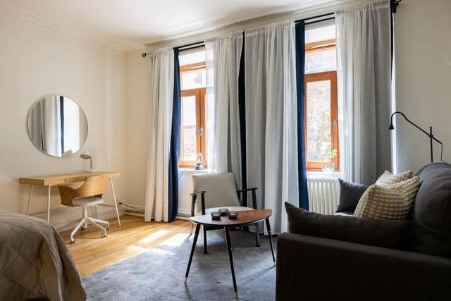 Cozy dining area for two by the large window in Gothenburg.