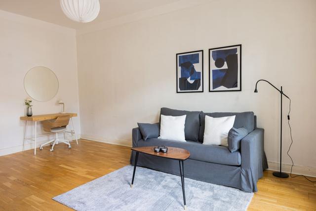 Living room with a convertible sofa in central Gothenburg apartment.