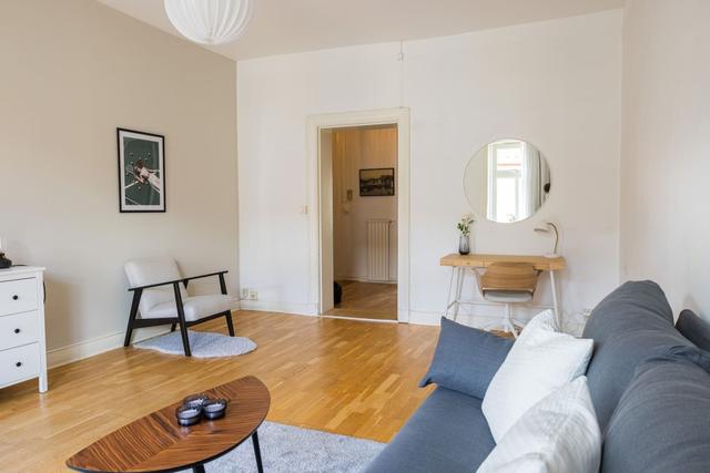 Living room with a convertible sofa in central Gothenburg apartment.