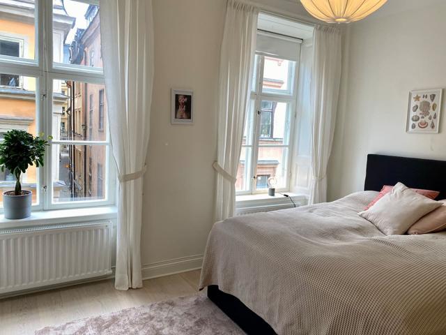 Cozy master bedroom with antique fireplace in Stockholm Old Town