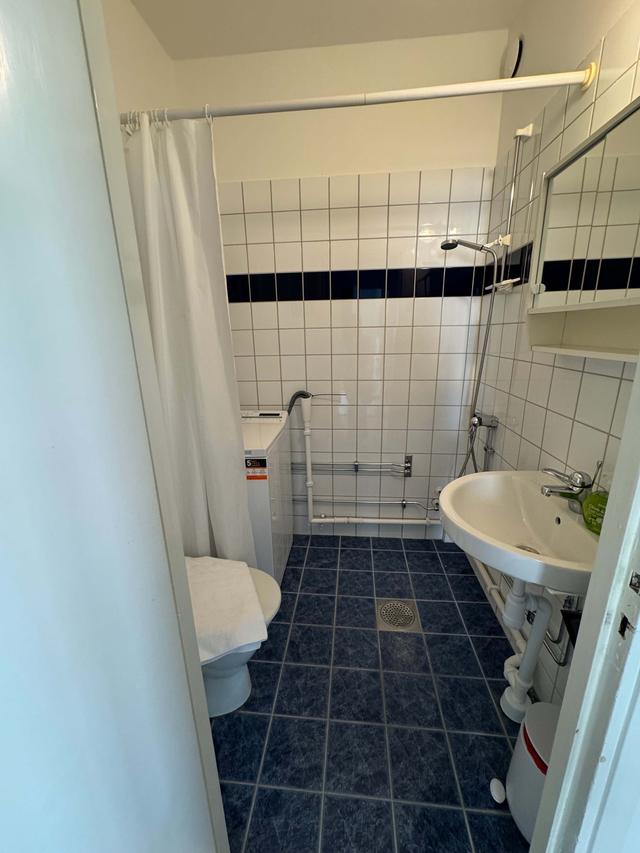 Cozy one-bedroom apartment interior in Sundbyberg with workspace and separate kitchen