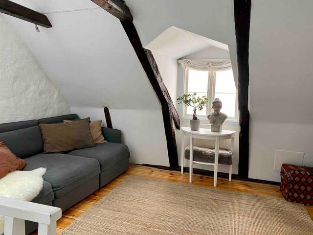 Loft apartment in Stockholm's Old Town with wooden beams.