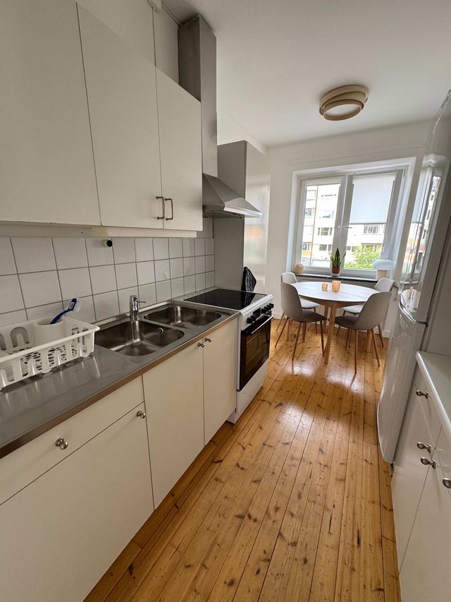 Cozy one-bedroom apartment interior in Sundbyberg with workspace and separate kitchen