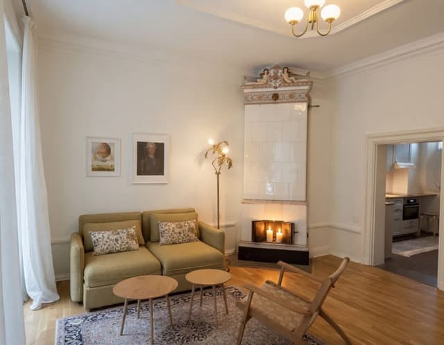 1BR apartment in Old Town with modern kitchen and large windows facing a pedestrian street