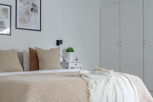 Living room with sofa bed and office space in Södermalm apartment