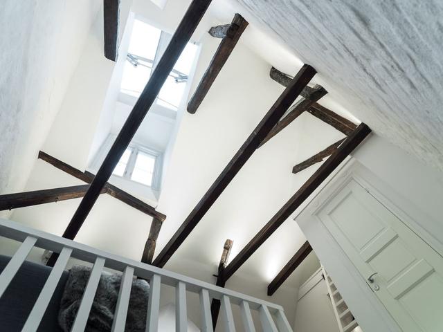 Loft apartment in Stockholm's Old Town with wooden beams.