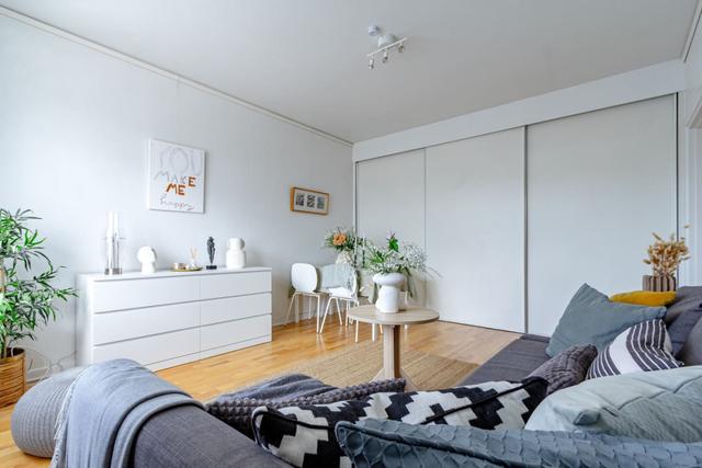 Comfortable living room with balcony access in Globen apartment