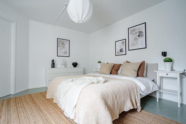 Living room with sofa bed and office space in Södermalm apartment