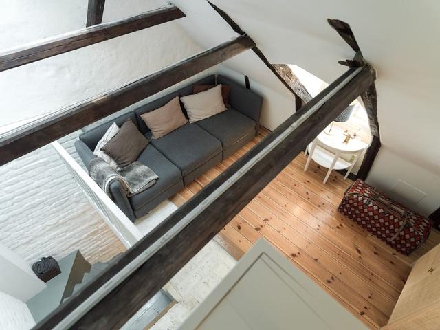 Loft apartment in Stockholm's Old Town with wooden beams.