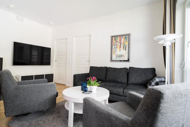 Bright living room with TV in Åre apartment