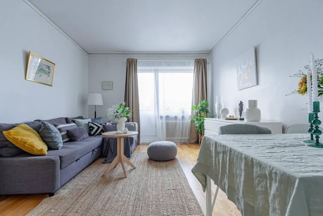 Comfortable living room with balcony access in Globen apartment