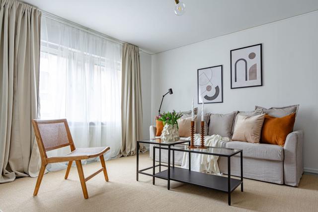 Living room with sofa bed and office space in Södermalm apartment