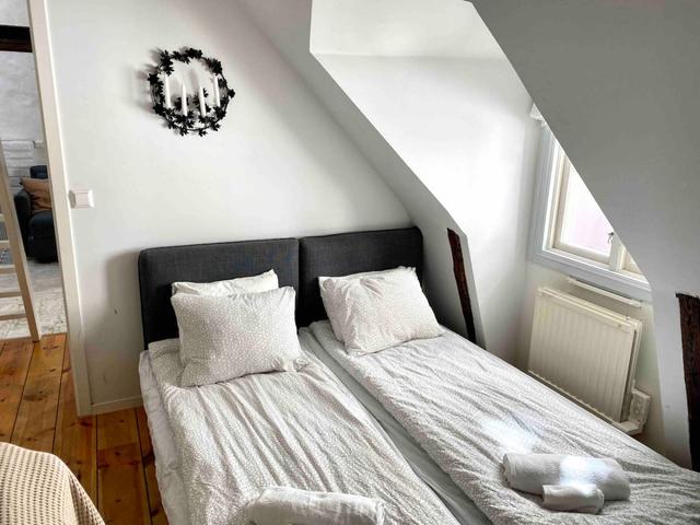 Loft apartment in Stockholm's Old Town with wooden beams.