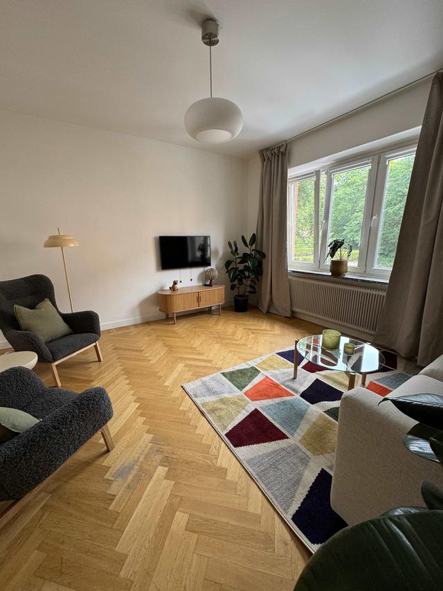 Cozy one-bedroom apartment interior in Sundbyberg with workspace and separate kitchen