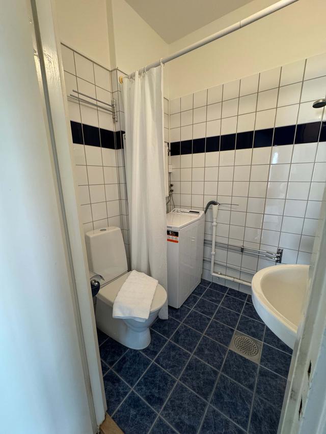 Cozy one-bedroom apartment interior in Sundbyberg with workspace and separate kitchen