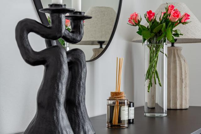 Living room with sofa bed and dining table in Södermalm apartment