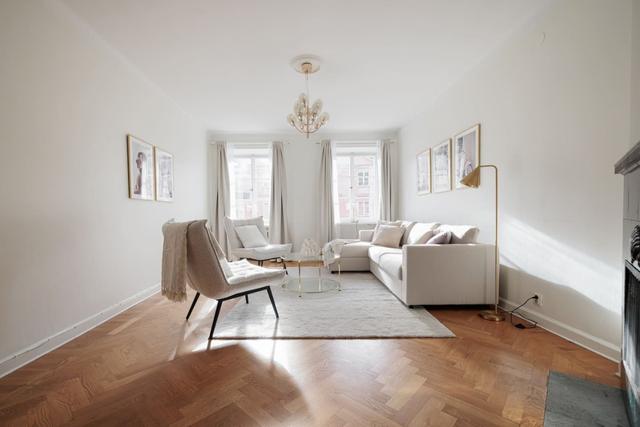 Living room in Vasastan apartment with large windows