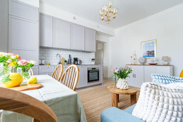 Open-concept living room and kitchen in a stylish apartment.